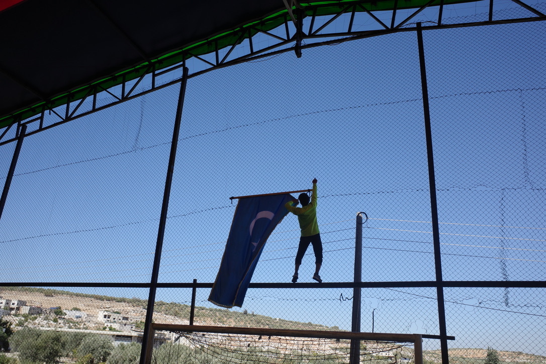 A man holding a Uyghur flag